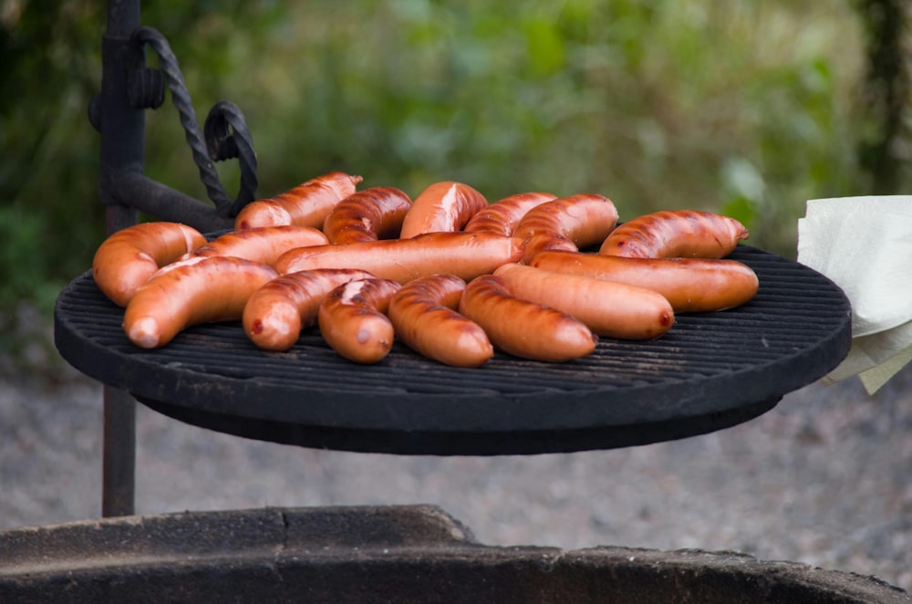 a bunch of hot dogs are on a grill