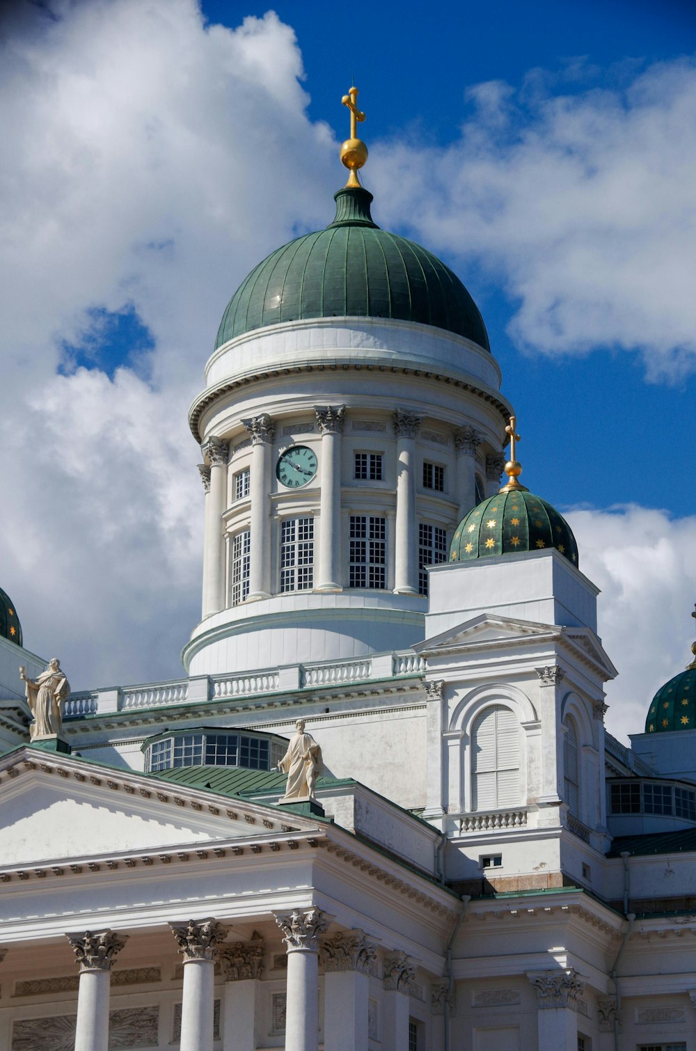 a large white building with a green dome