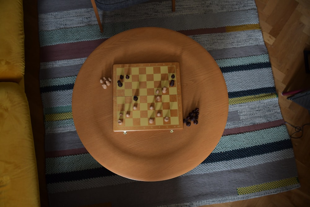 a chess board sitting on top of a wooden table