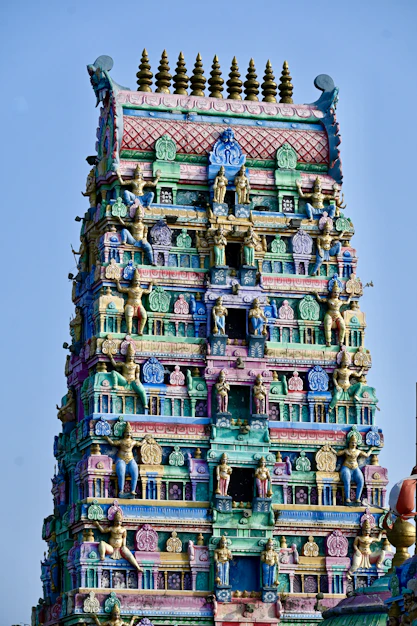 a very tall colorful building with a clock on it's face