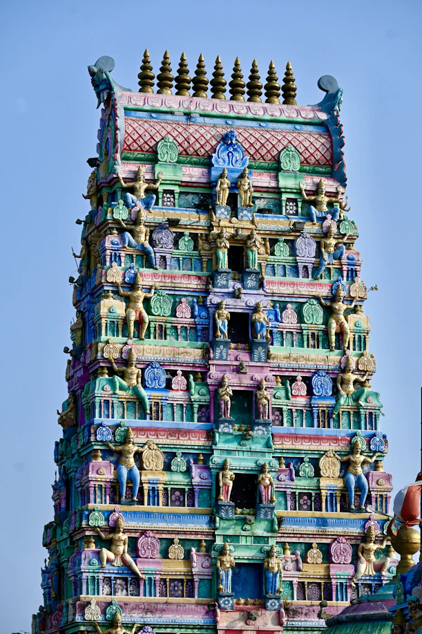 a very tall colorful building with a clock on it's face