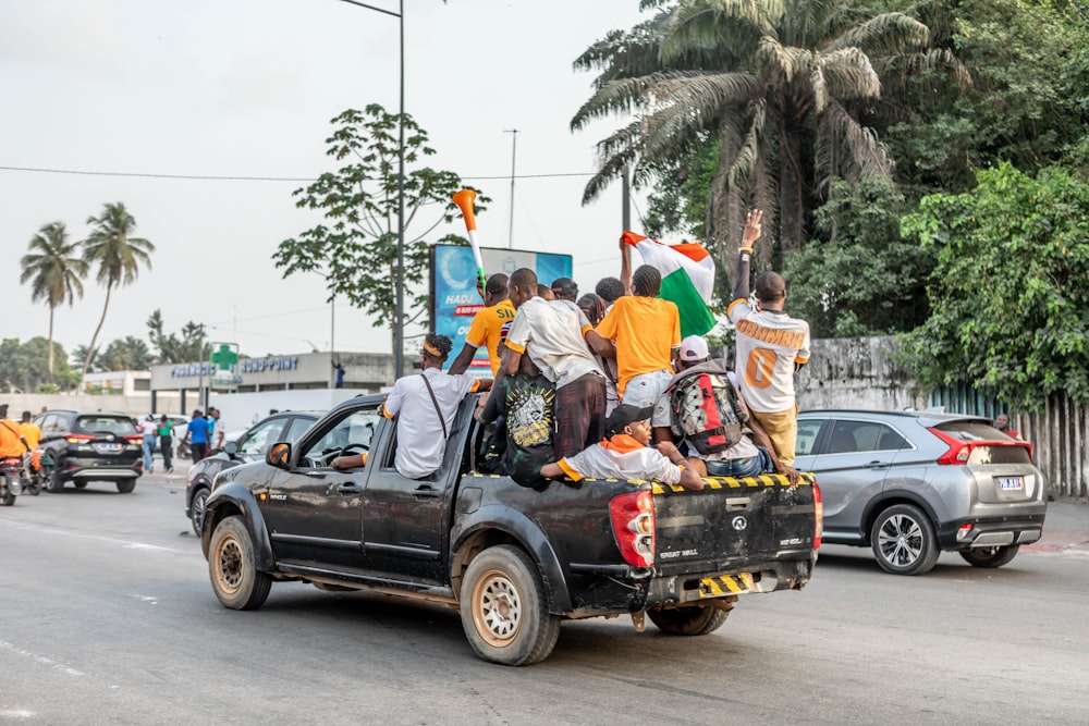 a group of people riding in the back of a truck