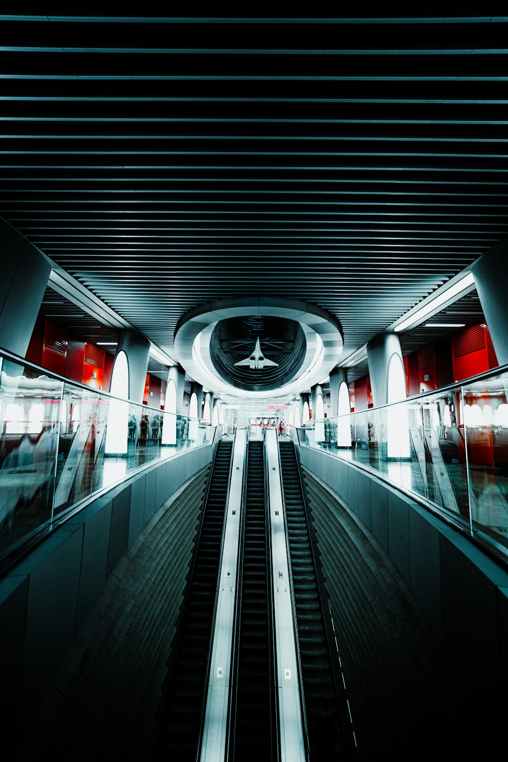 an airplane is flying over an escalator at an airport