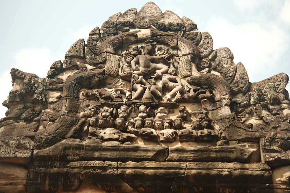 a large stone structure with a statue on top of it