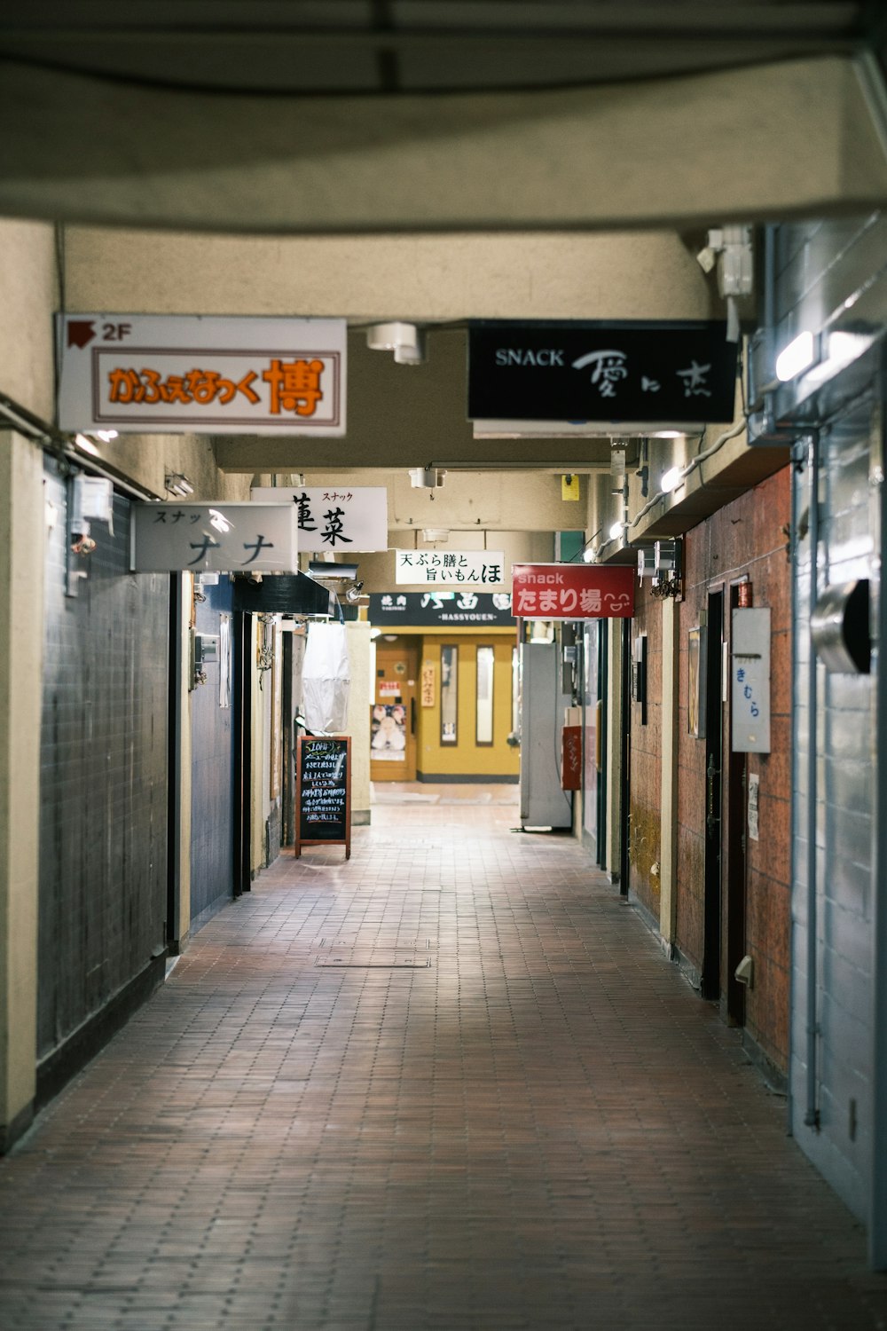 a long hallway with a sign on the side of it
