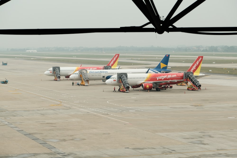 a couple of airplanes that are on a runway