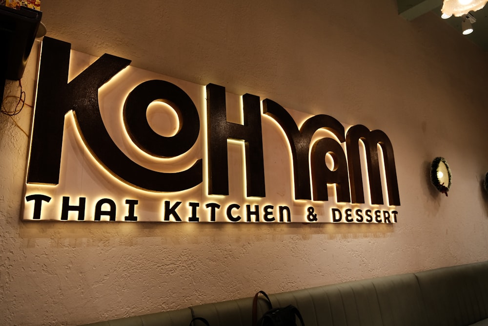 a restaurant sign that reads kolim thai kitchen and dessert