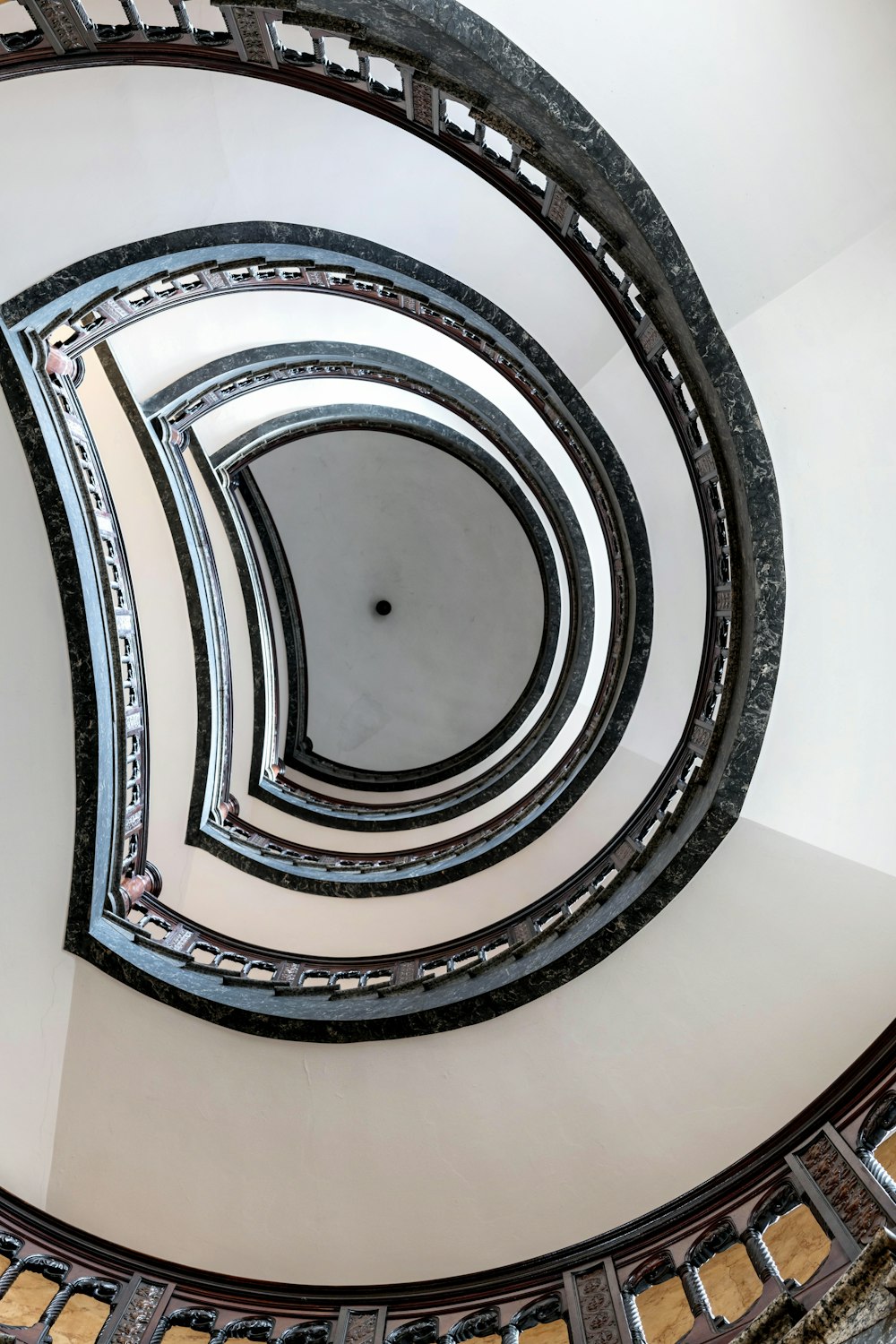 a spiral staircase in a building with a skylight