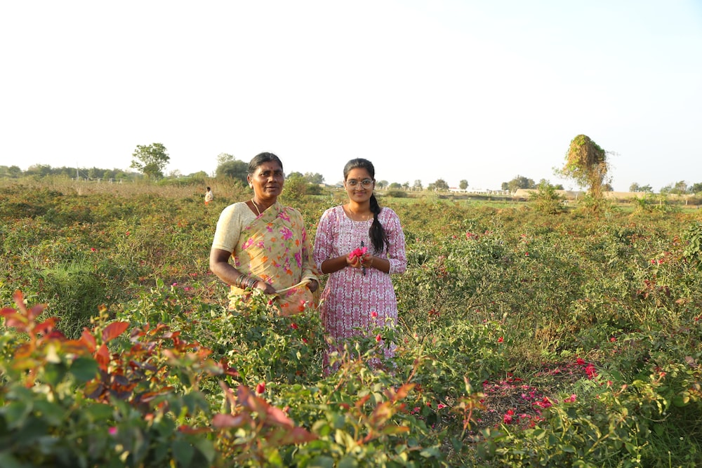 a man and a woman standing in a field