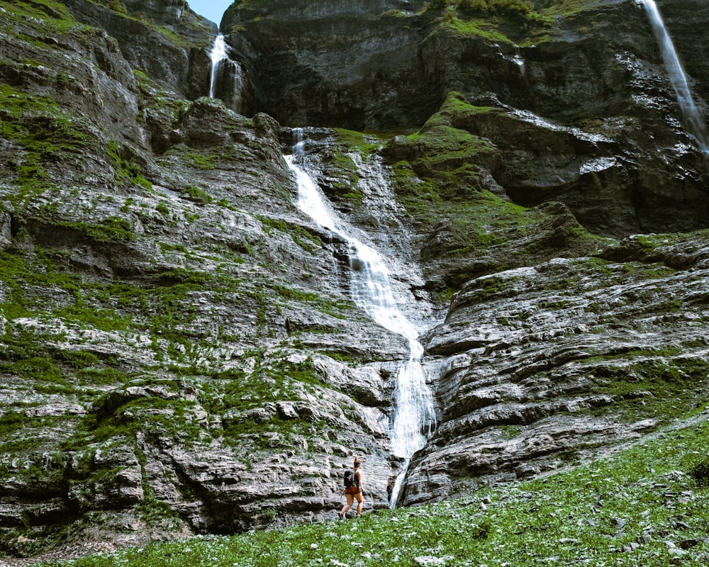 a person standing in front of a waterfall