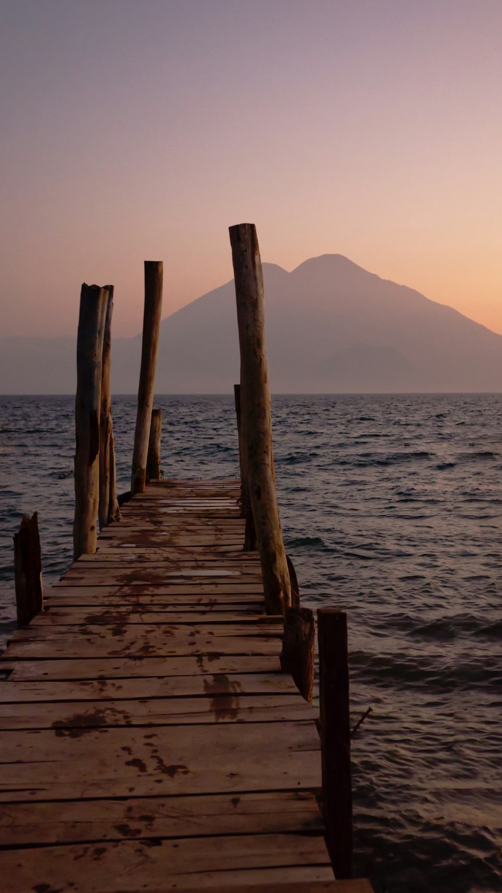 a wooden dock in the middle of a body of water