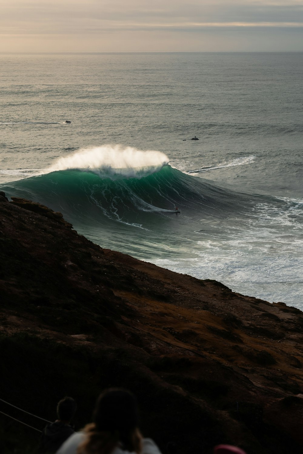 a person riding a wave on top of a surfboard