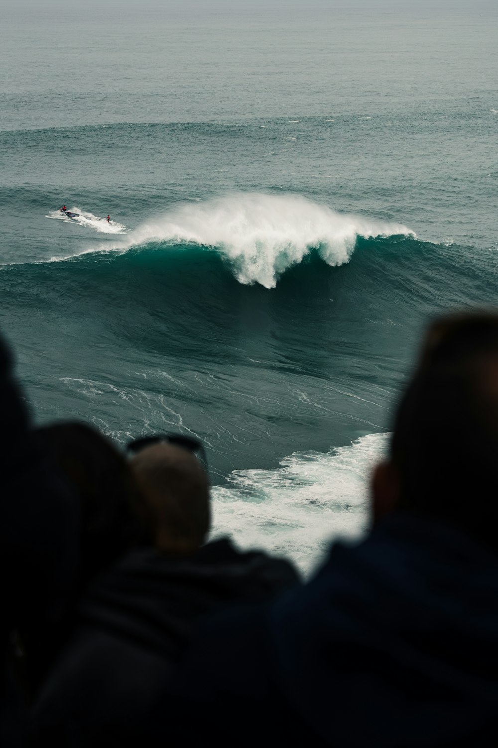 a man riding a wave on top of a surfboard