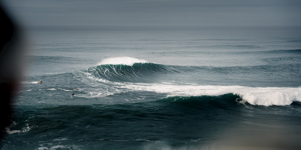 a person riding a wave on top of a surfboard