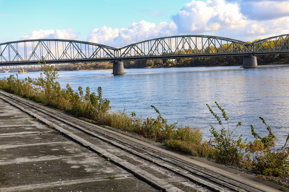 a train track next to a body of water