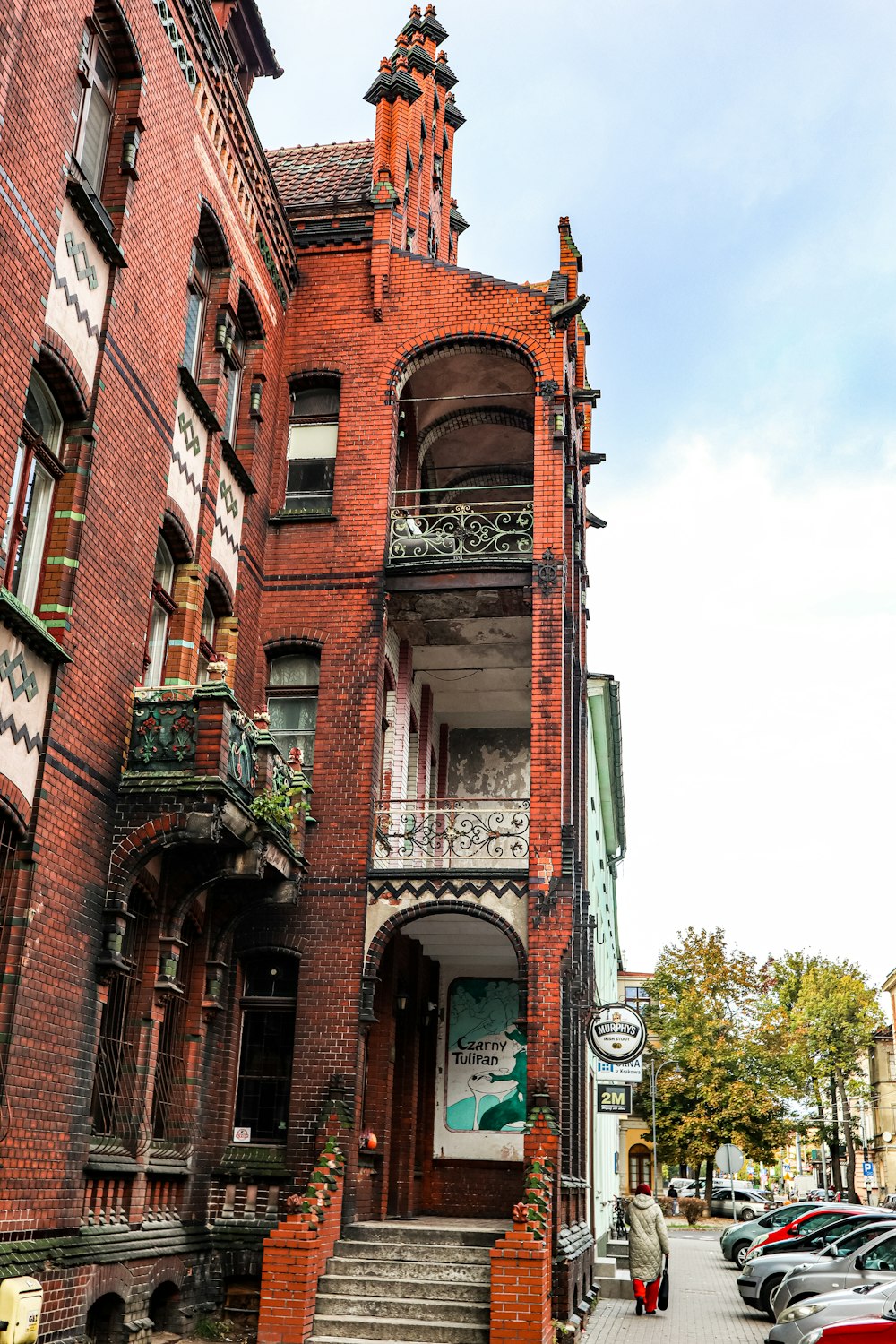 a tall red brick building sitting next to a street