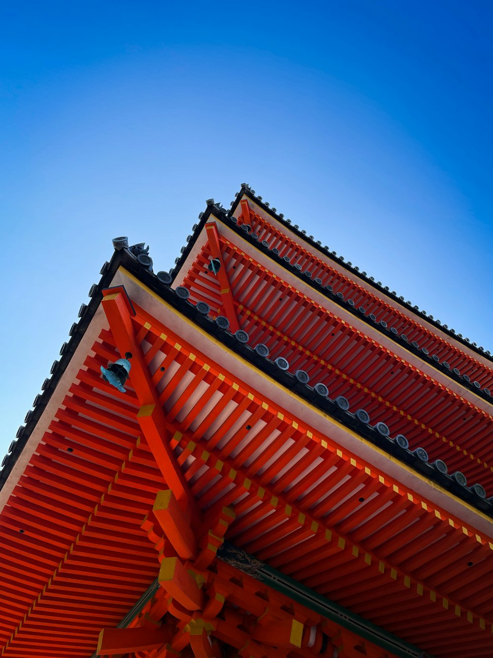 a tall red building with a blue sky in the background