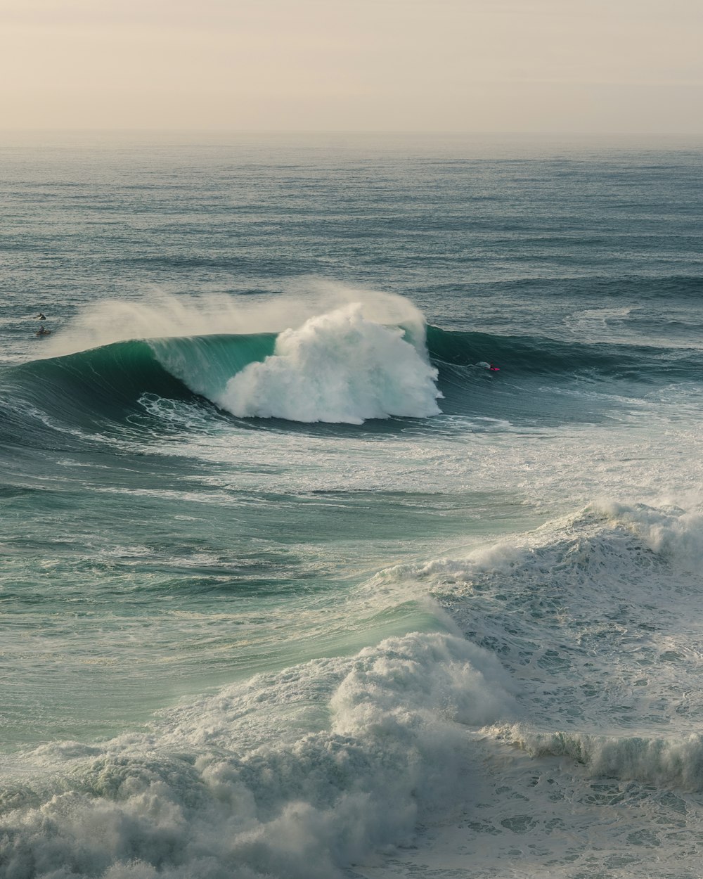 a surfer riding a large wave in the ocean