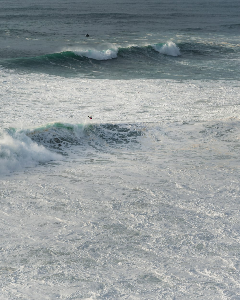 a person riding a surfboard on a wave in the ocean