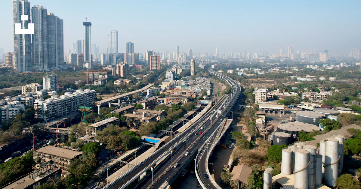 An aerial view of a city with a train on the tracks photo – Free ...