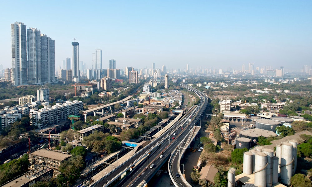 an aerial view of a city with a train on the tracks