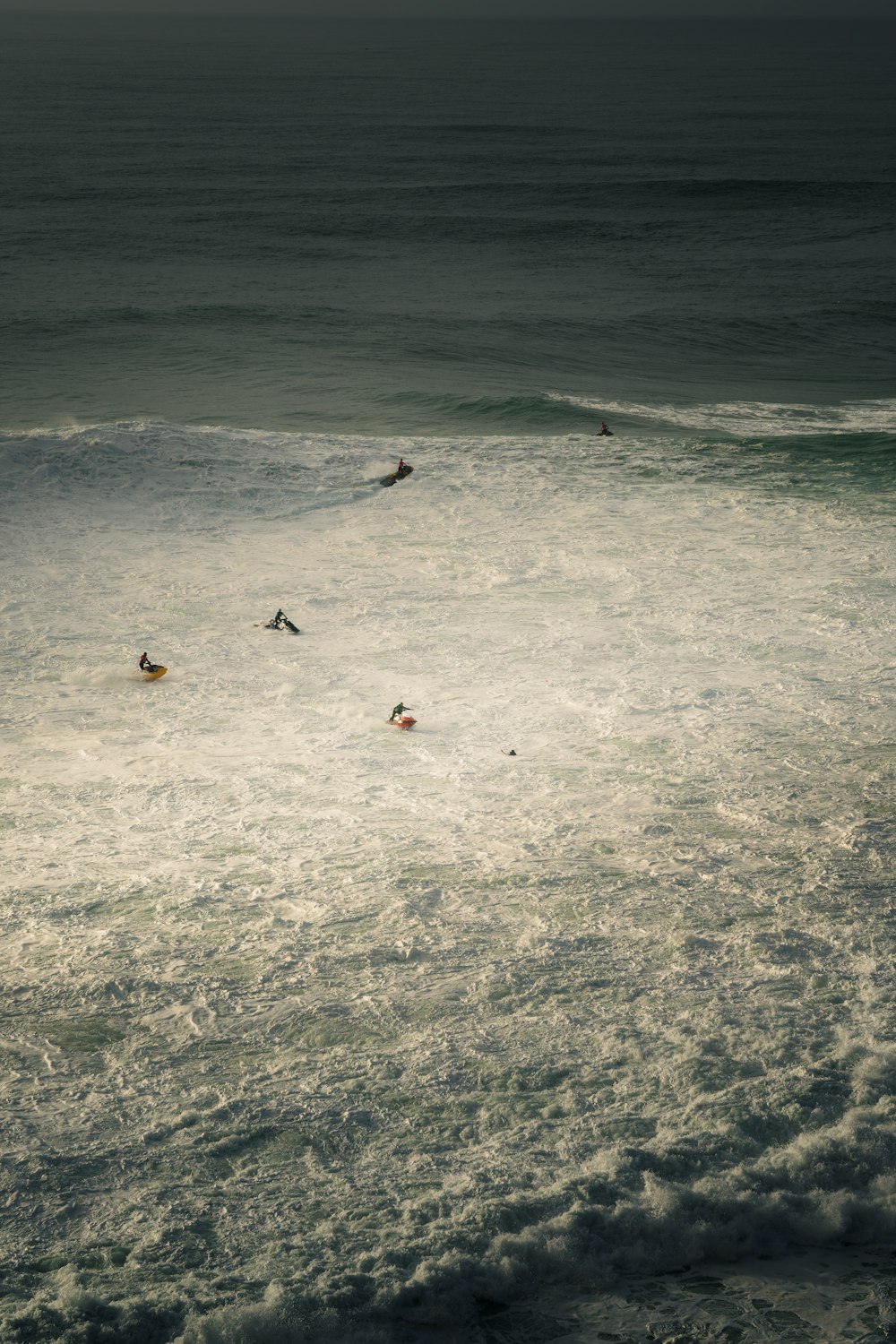 a group of people swimming in the ocean