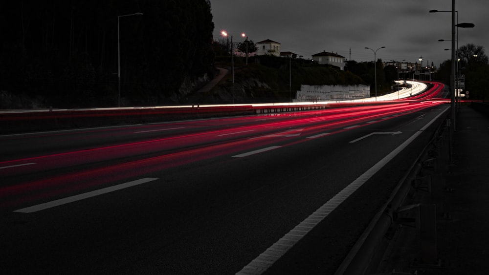 a long exposure photo of a highway at night