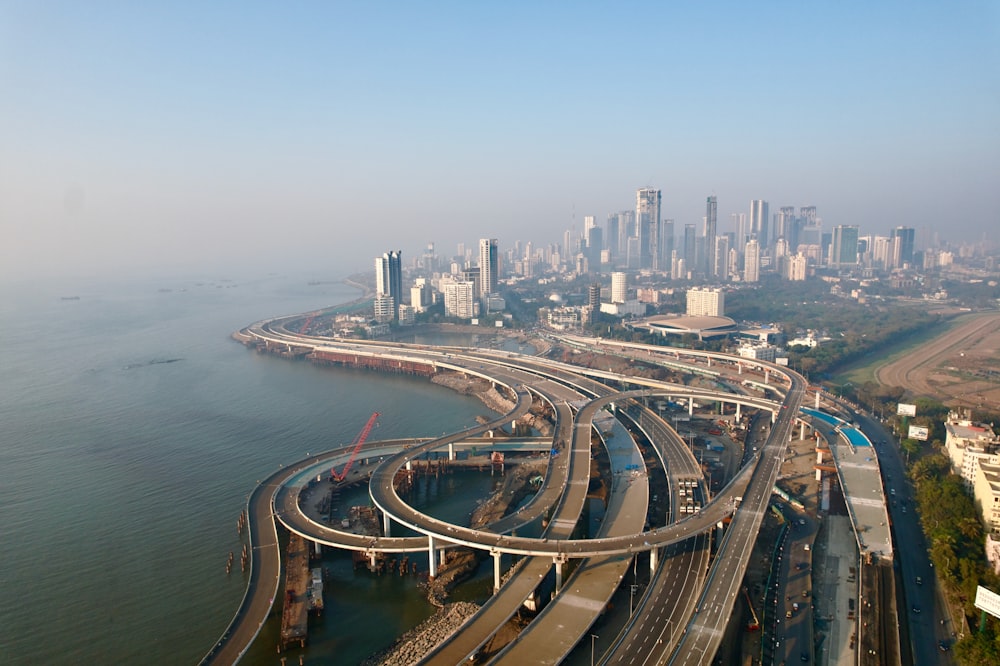 an aerial view of a highway with a city in the background