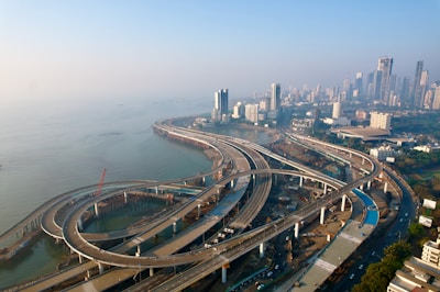 an aerial view of a highway with a city in the background