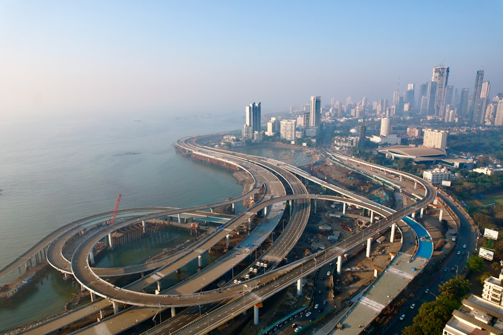 an aerial view of a highway with a city in the background