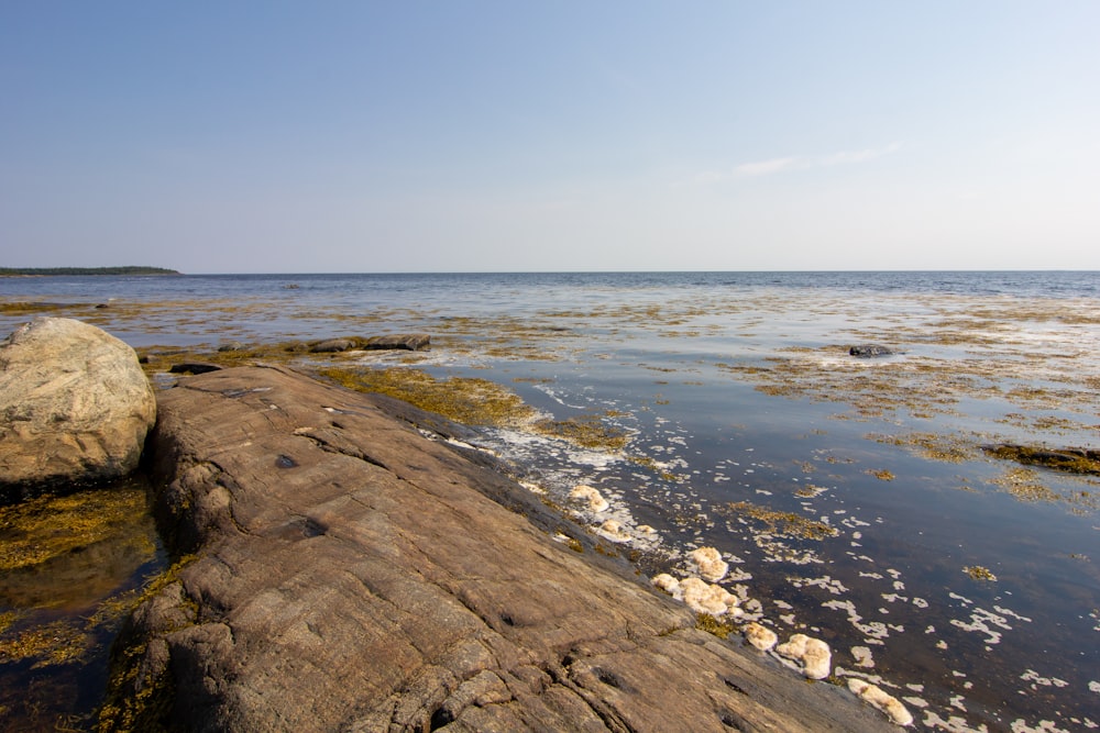 a large rock in the middle of a body of water