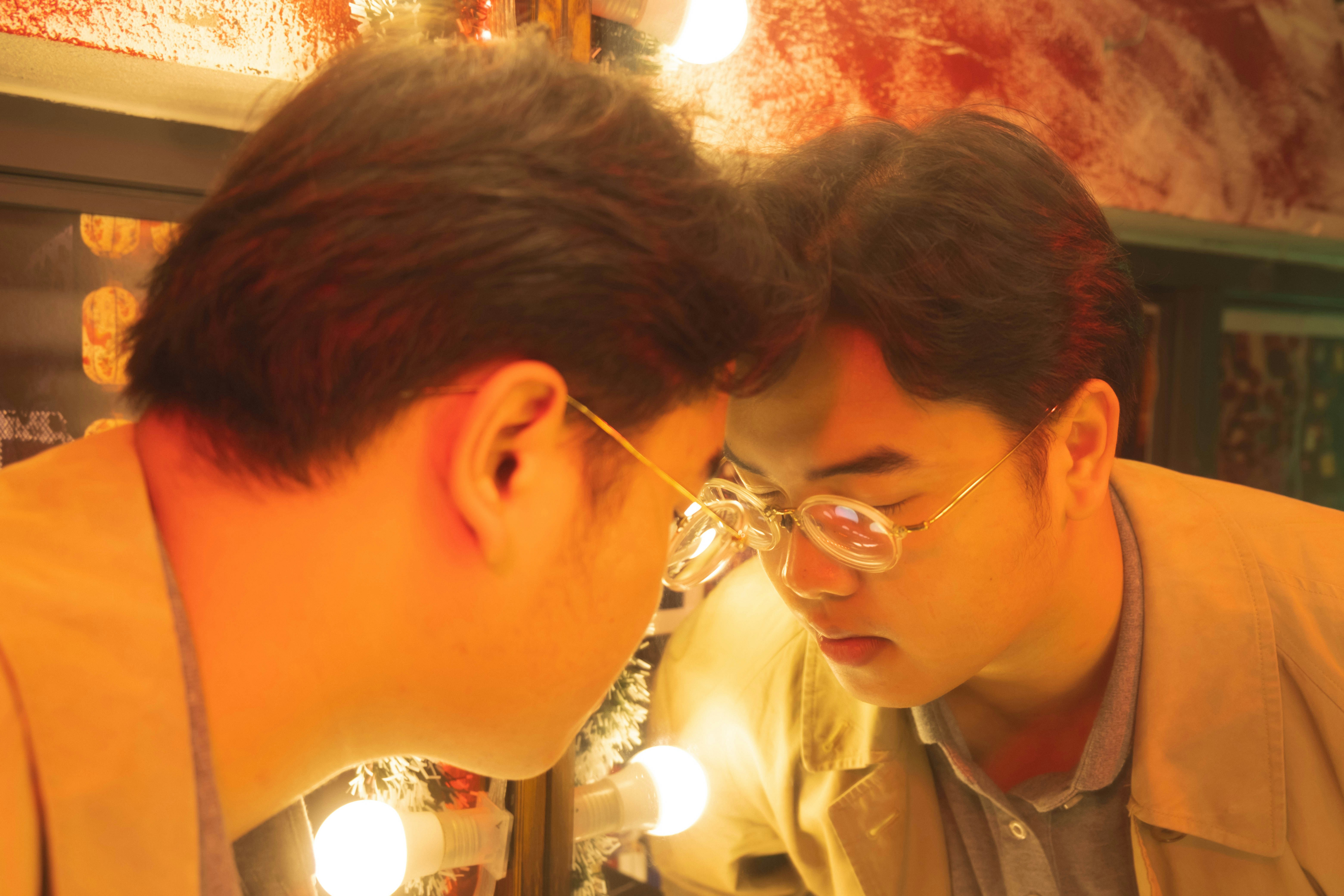 Surgeon consulting with a patient, pointing to areas of the face in a mirror - awake facelift beverly hills
