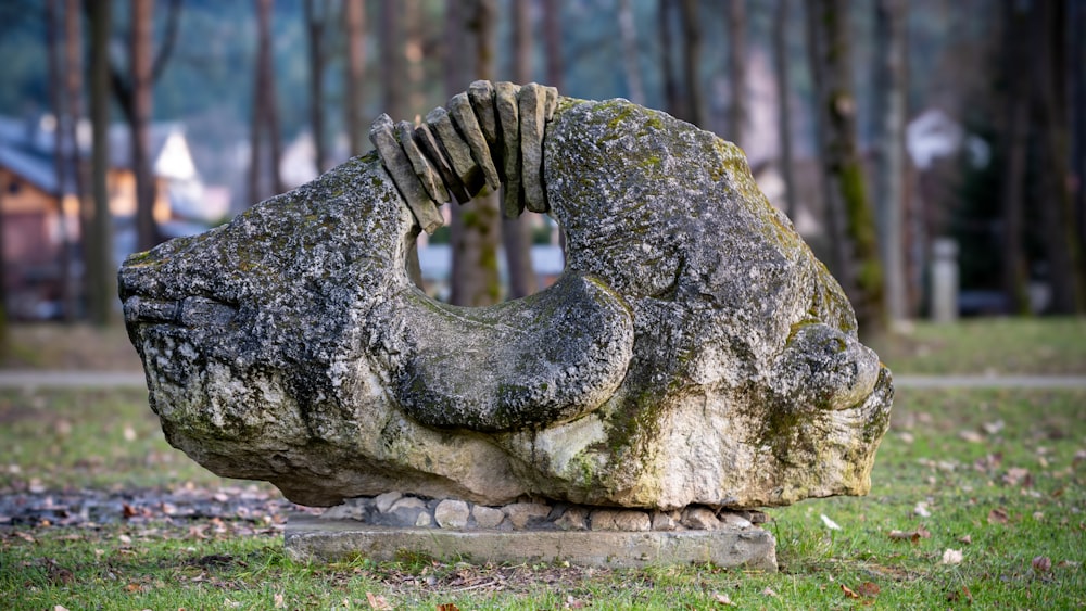 a stone sculpture in the middle of a park