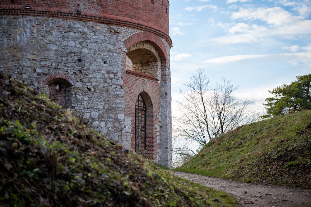 a stone tower with a door on top of a hill