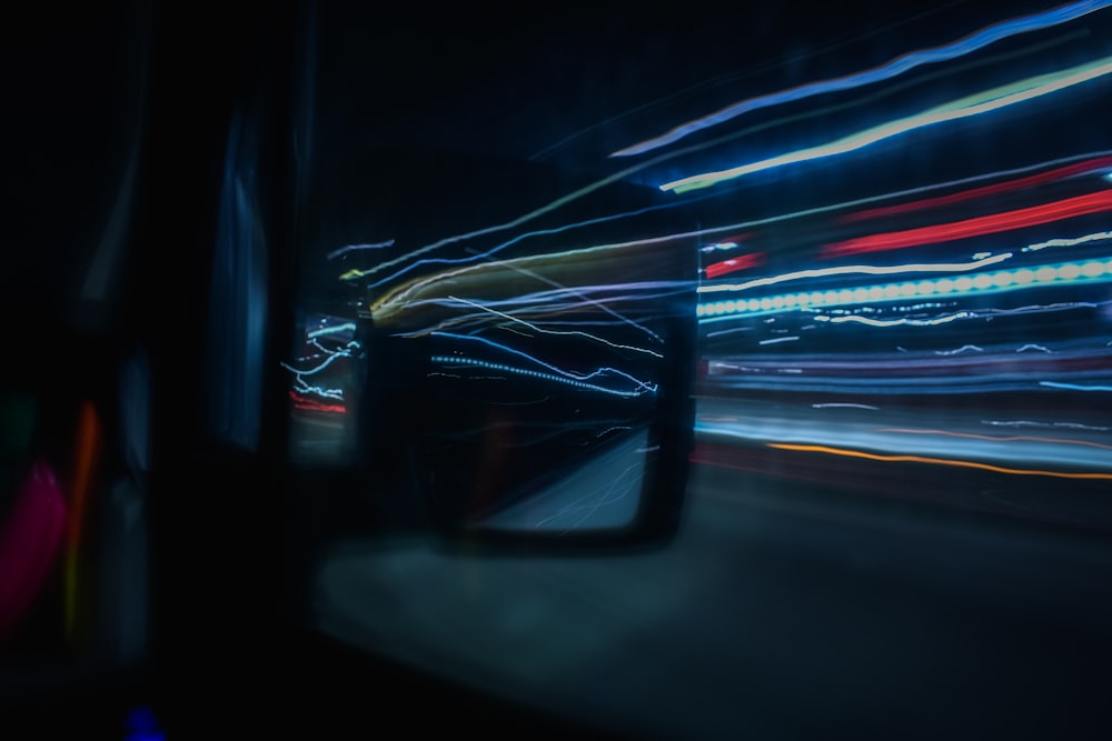 a blurry photo of a car's rear view mirror