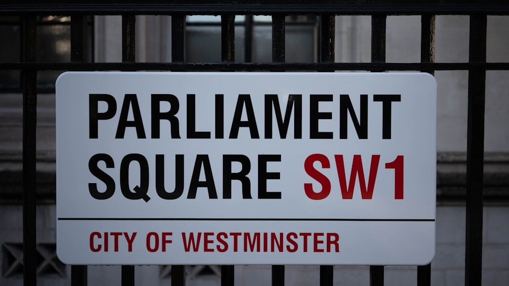 Ein Schild an einem Zaun mit der Aufschrift Parliament Square SW1