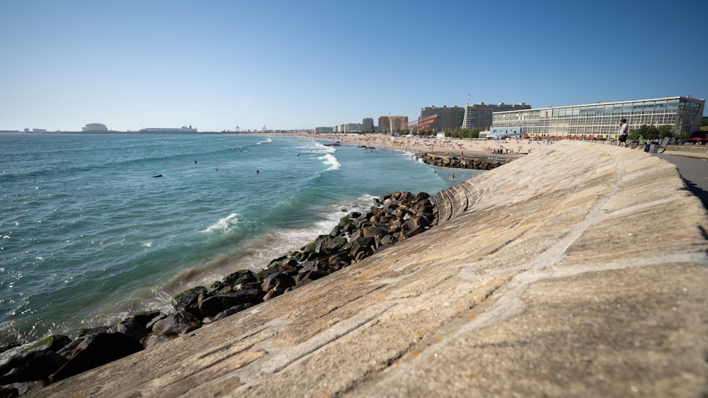 a view of a beach with people swimming in the water