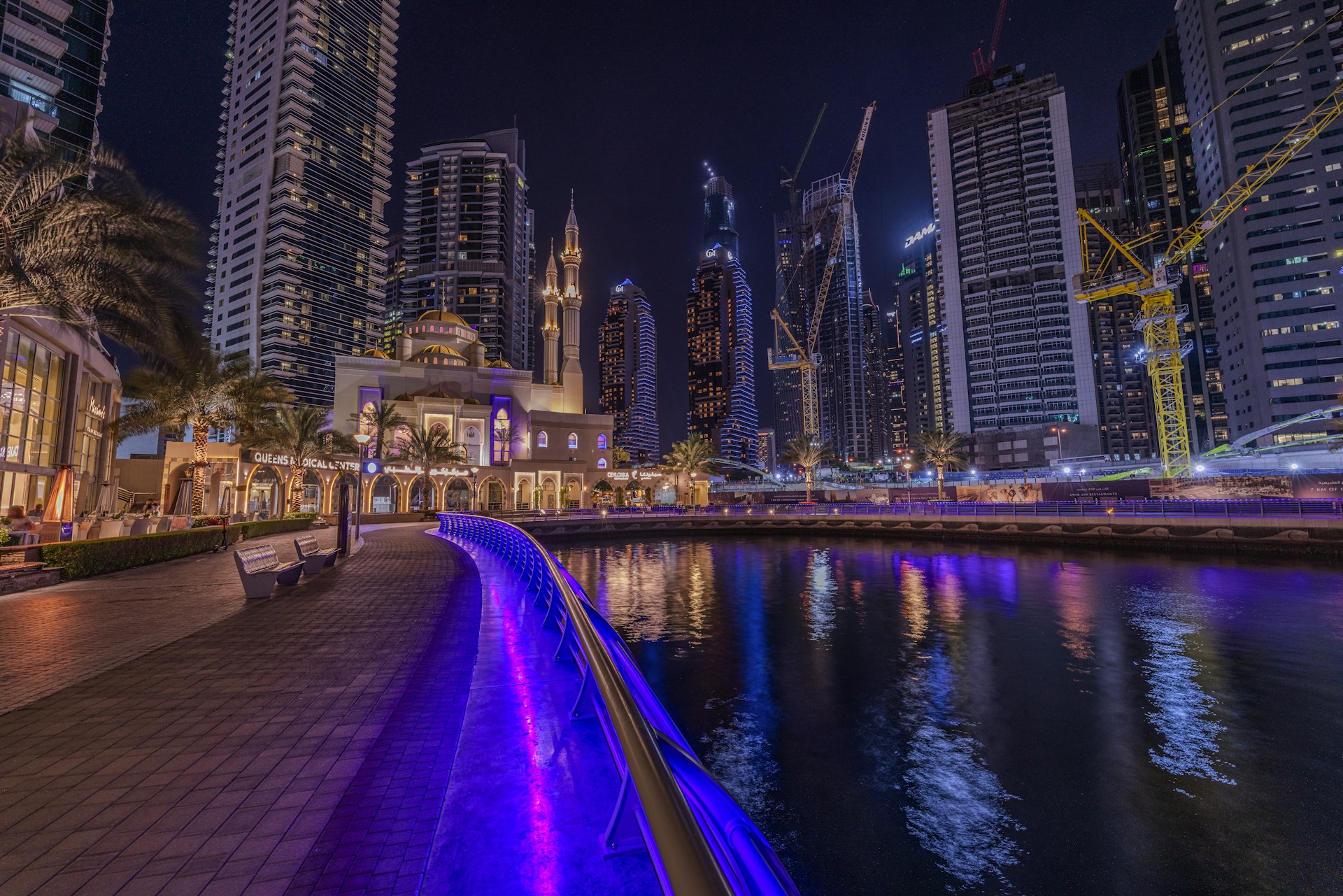a city at night with lights reflecting in the water