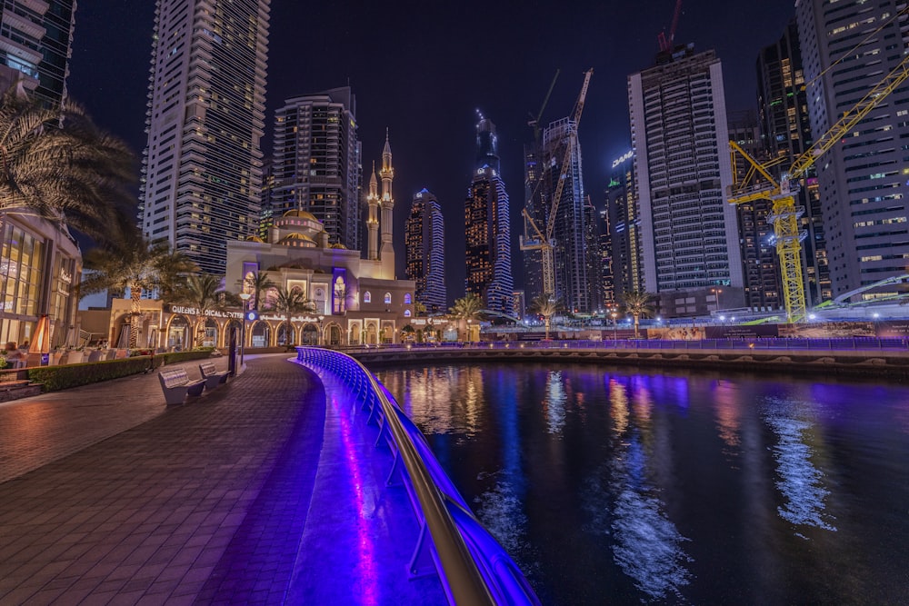 a city at night with lights reflecting in the water