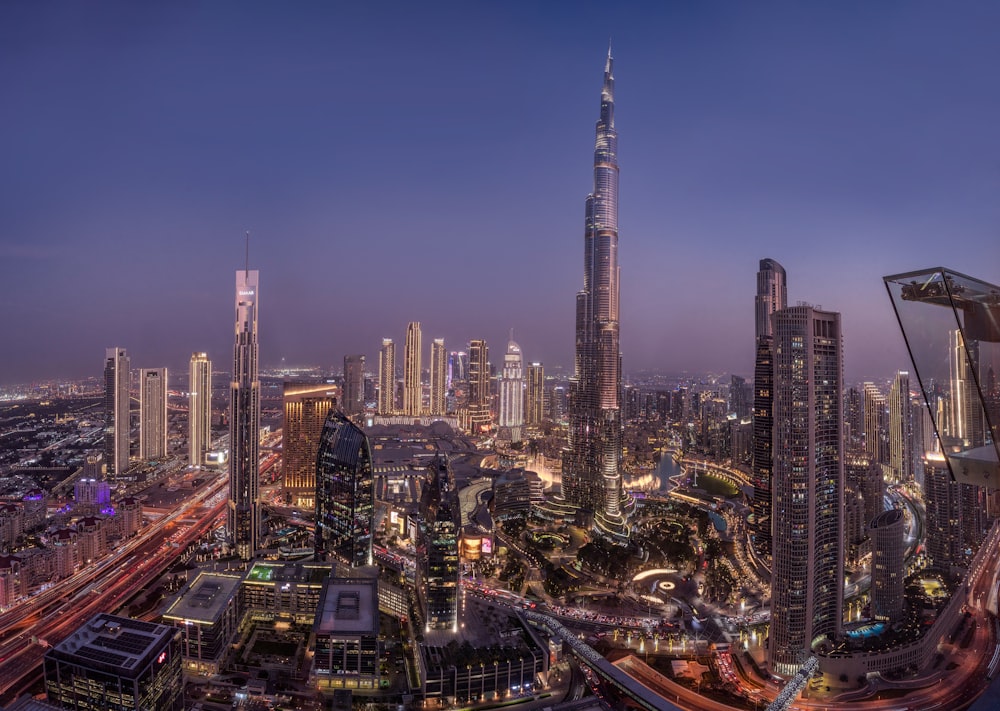 a view of a city at night from the top of a skyscraper