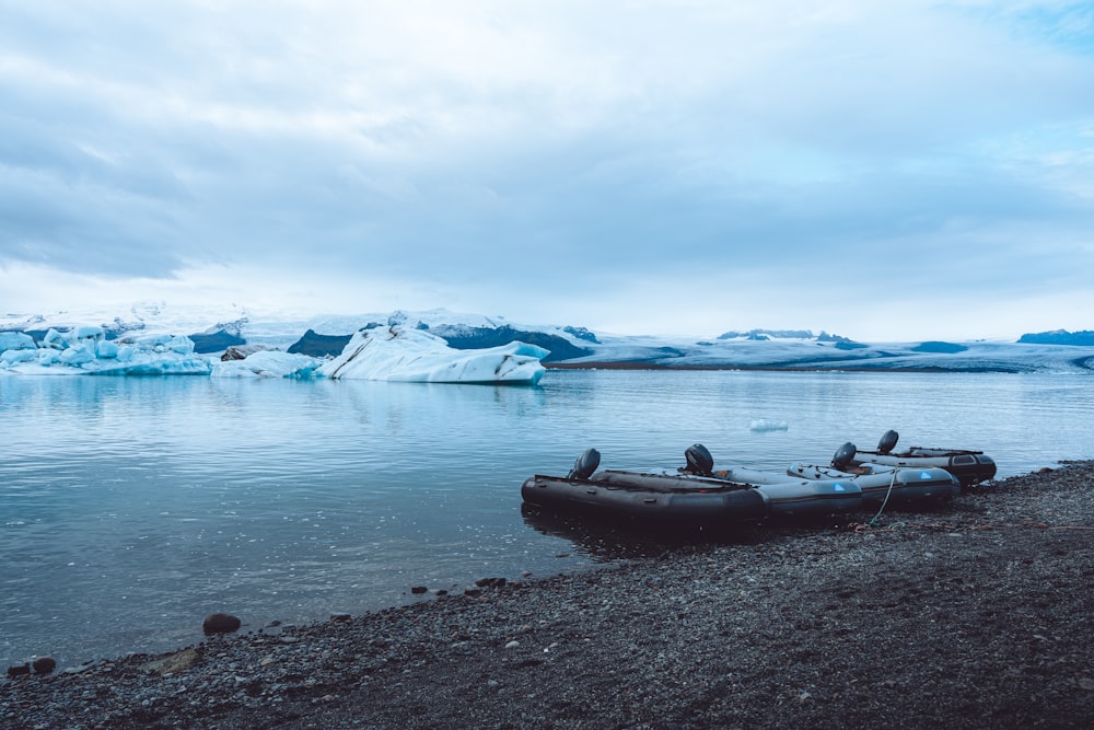 a couple of boats sitting on top of a lake