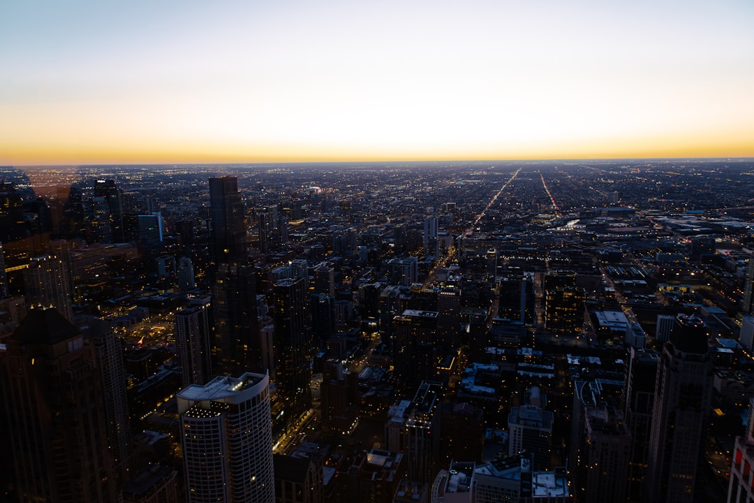 an aerial view of a city at sunset,