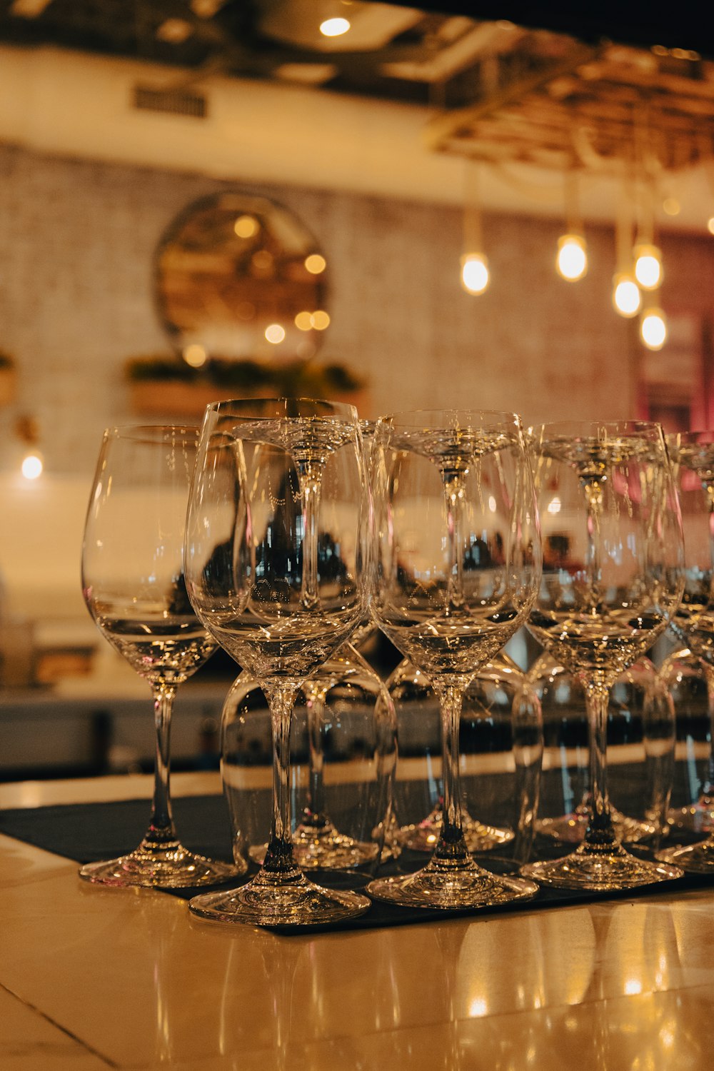 a row of wine glasses sitting on top of a counter