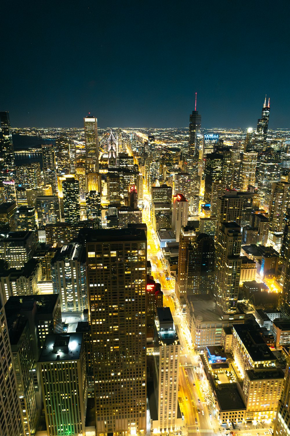 a view of a city at night from the top of a building