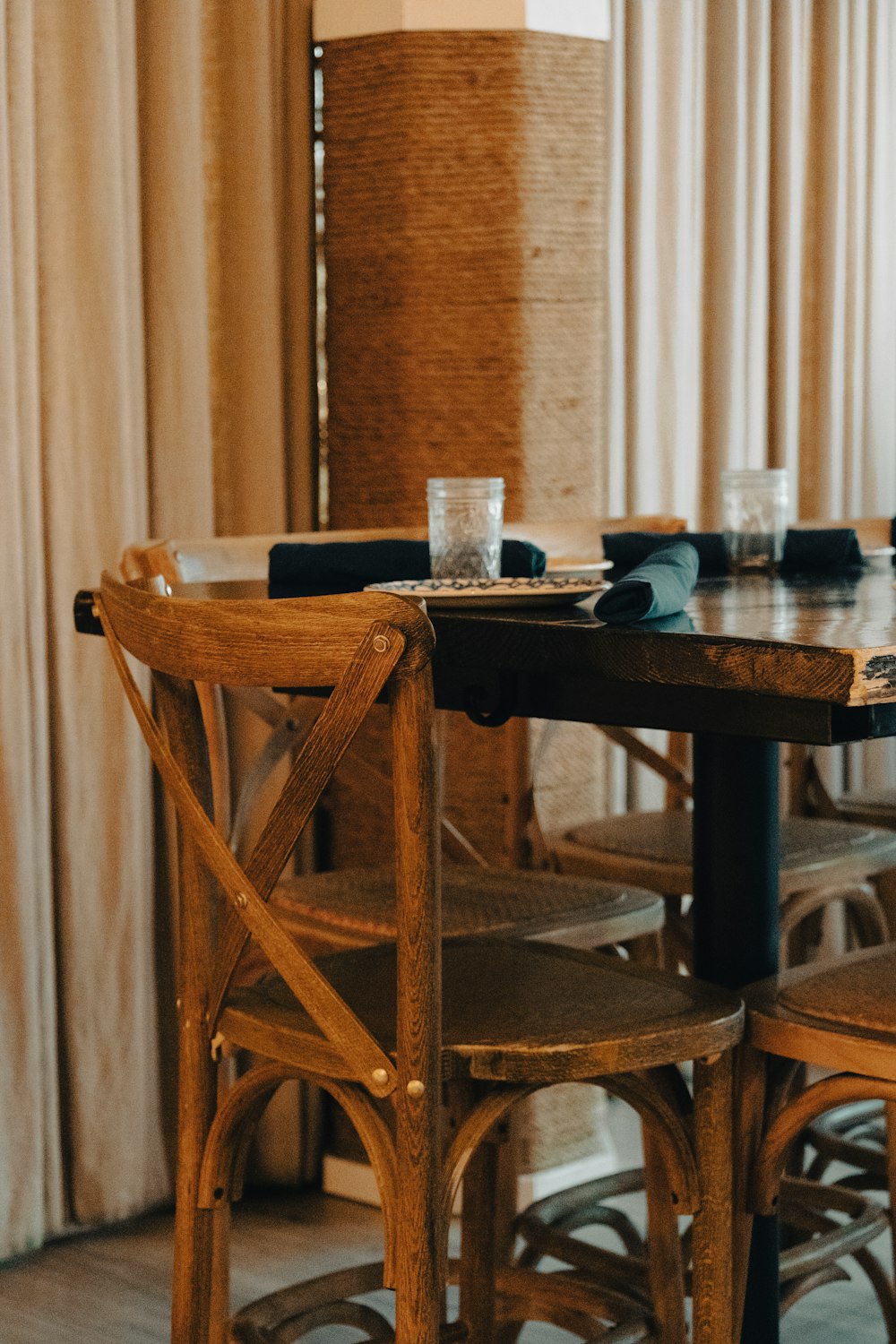 a wooden table and chairs in a room