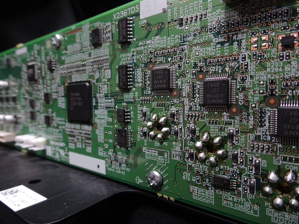 a close up of a green electronic board