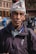 a man with a hat standing in the street