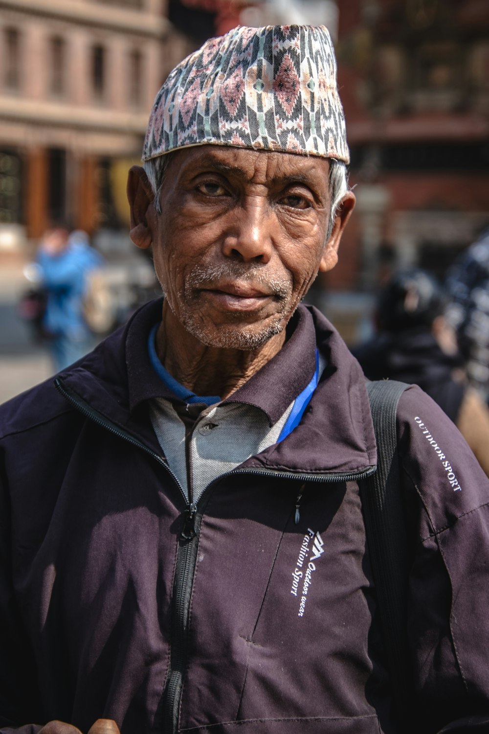 a man with a hat standing in the street