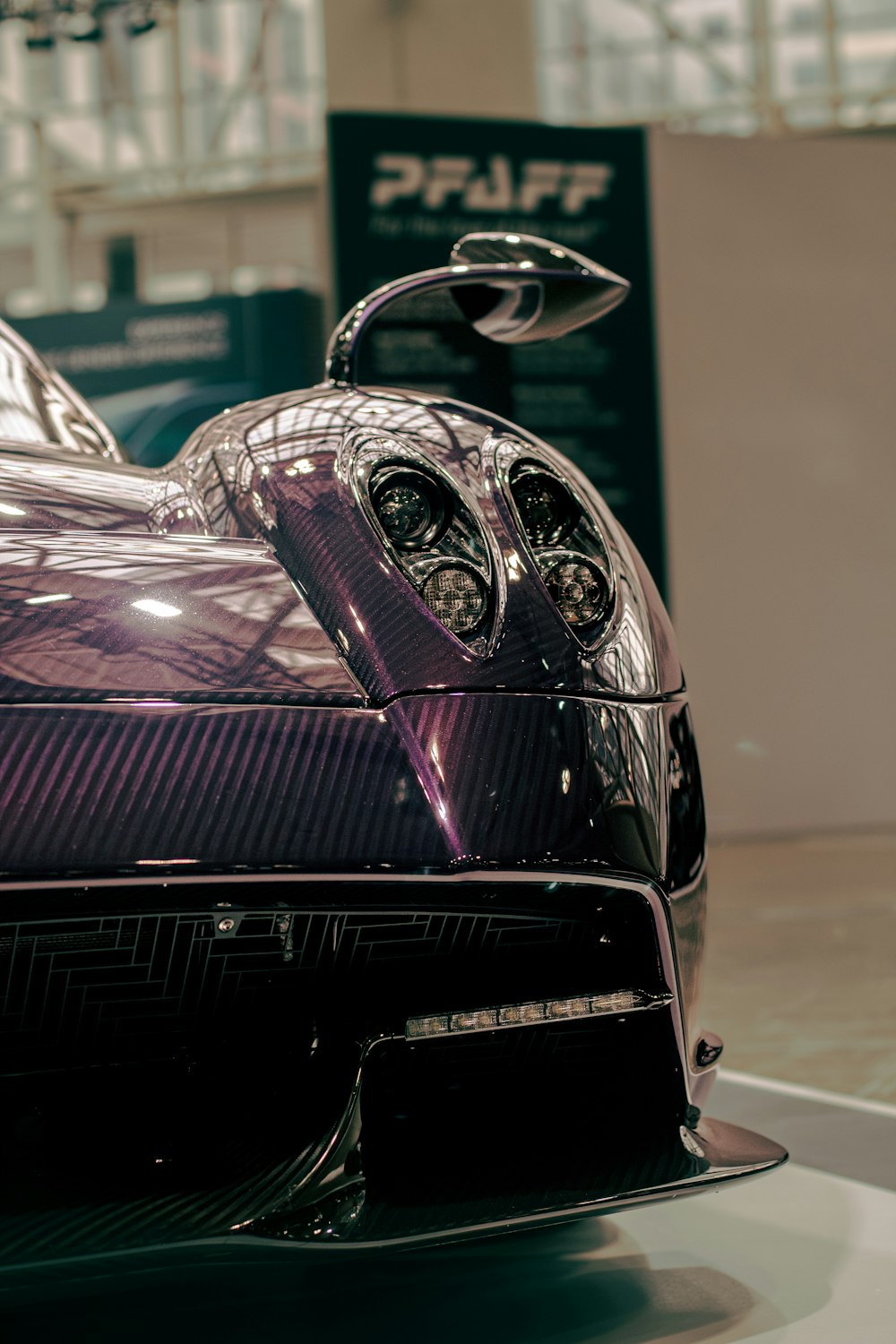 a close up of a shiny purple sports car