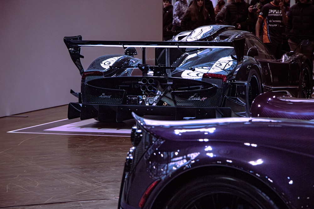 a purple sports car is on display at a car show